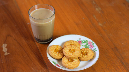 Breakfast and snack menu. Butter biscuits with pineapple jam and a glass of chocolate milk. Close-up of butter cookies and a glass of chocolate, sweet cakes. Perfect for recipes, articles, catalogs.