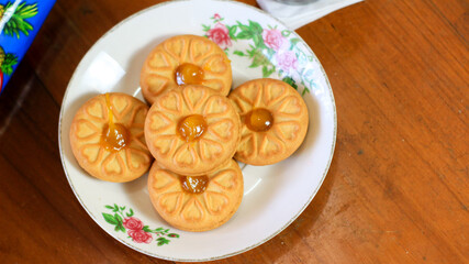 Breakfast and snack menu. Butter biscuits with pineapple jam and a glass of chocolate milk. Close-up of butter cookies and a glass of chocolate, sweet cakes. Perfect for recipes, articles, catalogs.