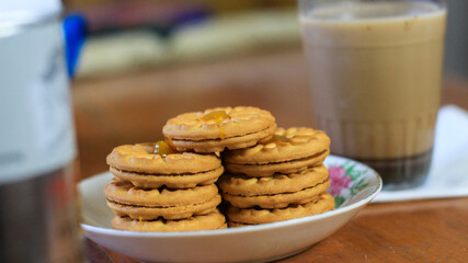 Breakfast and snack menu. Butter biscuits with pineapple jam and a glass of chocolate milk. Close-up of butter cookies and a glass of chocolate, sweet cakes. Perfect for recipes, articles, catalogs.
