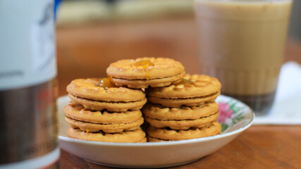 Breakfast and snack menu. Butter biscuits with pineapple jam and a glass of chocolate milk. Close-up of butter cookies and a glass of chocolate, sweet cakes. Perfect for recipes, articles, catalogs.