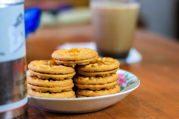 Breakfast and snack menu. Butter biscuits with pineapple jam and a glass of chocolate milk. Close-up of butter cookies and a glass of chocolate, sweet cakes. Perfect for recipes, articles, catalogs.