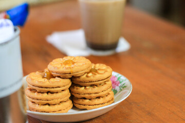 Breakfast and snack menu. Butter biscuits with pineapple jam and a glass of chocolate milk. Close-up of butter cookies and a glass of chocolate, sweet cakes. Perfect for recipes, articles, catalogs.
