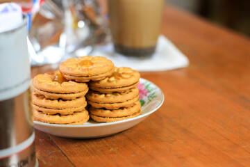 Breakfast and snack menu. Butter biscuits with pineapple jam and a glass of chocolate milk. Close-up of butter cookies and a glass of chocolate, sweet cakes. Perfect for recipes, articles, catalogs.