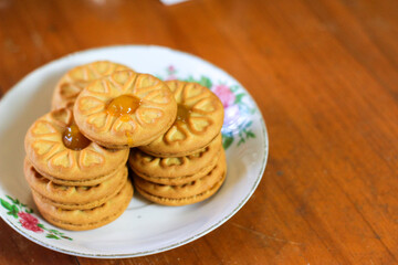 Breakfast and snack menu. Butter biscuits with pineapple jam and a glass of chocolate milk. Close-up of butter cookies and a glass of chocolate, sweet cakes. Perfect for recipes, articles, catalogs.