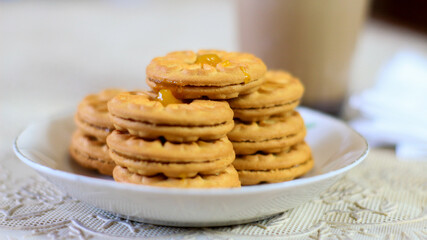 Breakfast and snack menu. Butter biscuits with pineapple jam and a glass of chocolate milk. Close-up of butter cookies and a glass of chocolate, sweet cakes. Perfect for recipes, articles, catalogs.