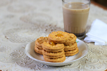Breakfast and snack menu. Butter biscuits with pineapple jam and a glass of chocolate milk. Close-up of butter cookies and a glass of chocolate, sweet cakes. Perfect for recipes, articles, catalogs.