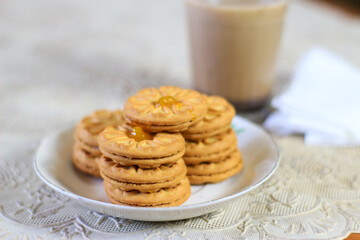 Breakfast and snack menu. Butter biscuits with pineapple jam and a glass of chocolate milk. Close-up of butter cookies and a glass of chocolate, sweet cakes. Perfect for recipes, articles, catalogs.
