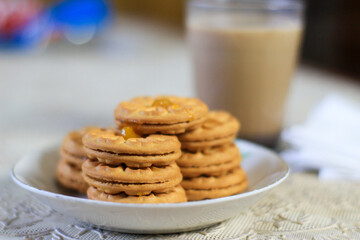 Breakfast and snack menu. Butter biscuits with pineapple jam and a glass of chocolate milk. Close-up of butter cookies and a glass of chocolate, sweet cakes. Perfect for recipes, articles, catalogs.