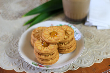 Breakfast and snack menu. Butter biscuits with pineapple jam and a glass of chocolate milk. Close-up of butter cookies and a glass of chocolate, sweet cakes. Perfect for recipes, articles, catalogs.