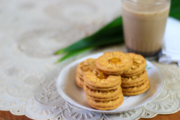 Breakfast and snack menu. Butter biscuits with pineapple jam and a glass of chocolate milk. Close-up of butter cookies and a glass of chocolate, sweet cakes. Perfect for recipes, articles, catalogs.