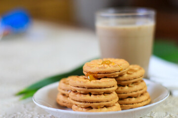Breakfast and snack menu. Butter biscuits with pineapple jam and a glass of chocolate milk. Close-up of butter cookies and a glass of chocolate, sweet cakes. Perfect for recipes, articles, catalogs.