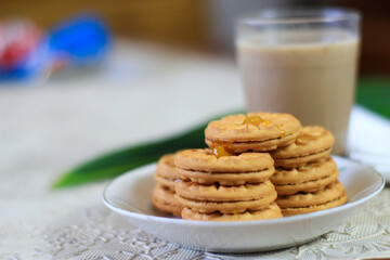 Breakfast and snack menu. Butter biscuits with pineapple jam and a glass of chocolate milk. Close-up of butter cookies and a glass of chocolate, sweet cakes. Perfect for recipes, articles, catalogs.
