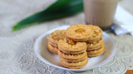 Breakfast and snack menu. Butter biscuits with pineapple jam and a glass of chocolate milk. Close-up of butter cookies and a glass of chocolate, sweet cakes. Perfect for recipes, articles, catalogs.