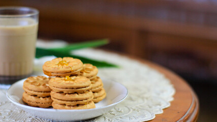 Breakfast and snack menu. Butter biscuits with pineapple jam and a glass of chocolate milk. Close-up of butter cookies and a glass of chocolate, sweet cakes. Perfect for recipes, articles, catalogs.