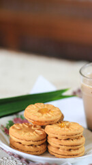 Breakfast and snack menu. Butter biscuits with pineapple jam and a glass of chocolate milk. Close-up of butter cookies and a glass of chocolate, sweet cakes. Perfect for recipes, articles, catalogs.