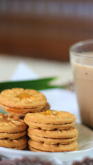 Breakfast and snack menu. Butter biscuits with pineapple jam and a glass of chocolate milk. Close-up of butter cookies and a glass of chocolate, sweet cakes. Perfect for recipes, articles, catalogs.