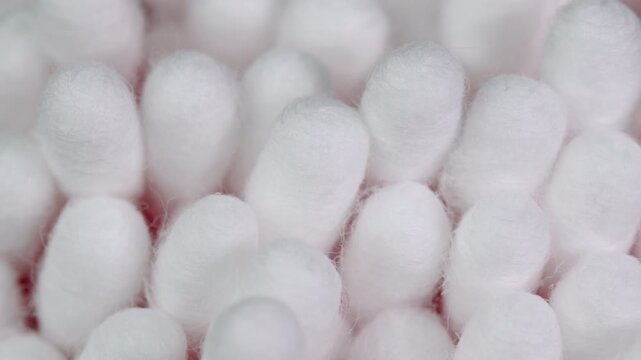 Cotton swabs rotating, cotton buds macro shot. Ear cleaning q-tips. Personal hygiene and cosmetic items