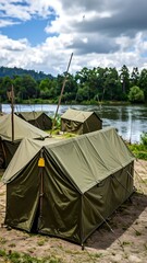 Military tents by a lake under a partly cloudy sky