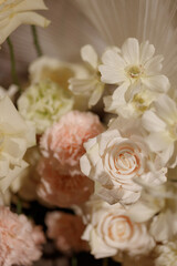 Wedding banquet table decorated with flowers, candles and food in festive hall with dark background. Concept of celebration, romance, event decoration, reception.
