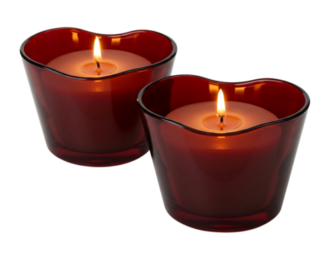 Two red heart shaped glass candle holders with lit candles isolated on transparent background