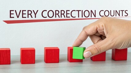 Hand placing green block among red blocks with text 'Every Correction Counts' highlighting importance of improvement