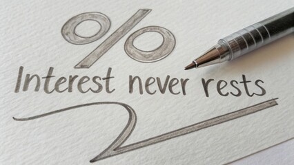 Handwritten financial concept with a percentage symbol, pen, and motivational message 'Interest never rests' on textured paper