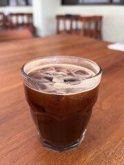 Glass of Iced Americano Coffee on Wooden Table