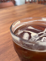 Close Up Glass of Iced Americano Coffee with Ice on Table