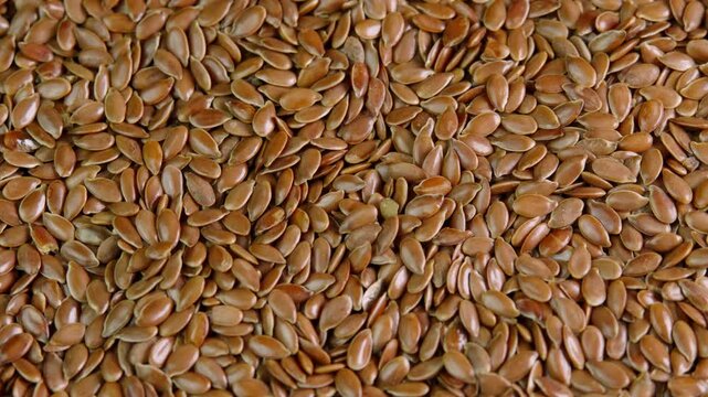 Flax seeds rotating top view close up. Linseed rotate. Healthy nutrition, dieting concepts, tasty and healthy food