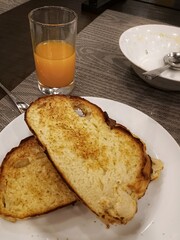 The bread looked dry, even burnt in parts, as it was toasted. It was a simple breakfast choice with a glass of freshly squeezed orange juice.