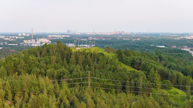 Drone flying around the Malminkartanonhuippu hill, summer day in Finland