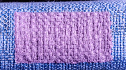 Purple fabric patch on blue-toned textiles