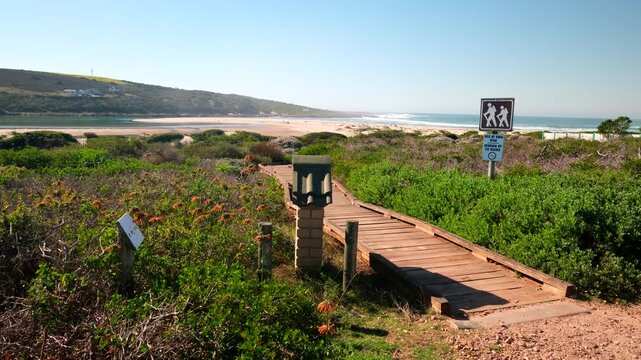 Wooden walkway through native coastal dune fynbos in scenic Gouritsmond, RSA