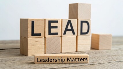 Wooden blocks spelling lead and emphasizing the importance of leadership in personal and professional growth