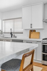 Modern living room with flat-screen TV, fireplace, and minimalist decor in natural light