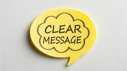 Yellow speech bubble note with handwritten text stating clear message for communication and expression in business settings