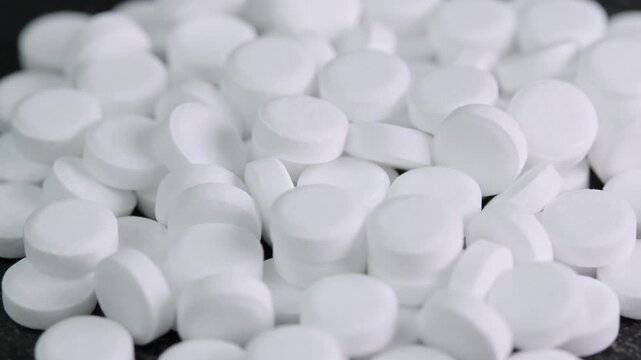 Sugar substitute pills rotating in macro. Artificial sweetener tablets zero calories