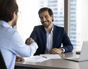 Hispanic Businessman Closing Deal in Office