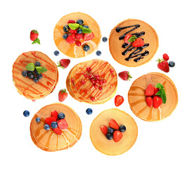 selection of pancakes with fruit, syrup, and chocolate sauce