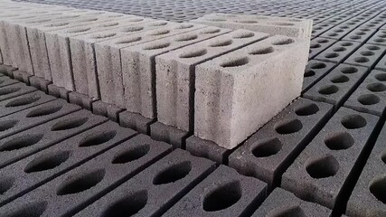 Closeup view of bricks for making houses, new bricks are a mixture of cement, sand and water. Footage.
