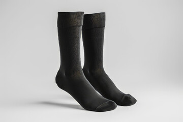 A pair of black socks displayed against a neutral background.