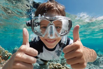 Fototapeta premium Young caucasian male child snorkeling underwater with thumbs up in tropical ocean