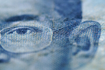 Close-Up of Detailed Banknote Design Featuring Eye and Glasses