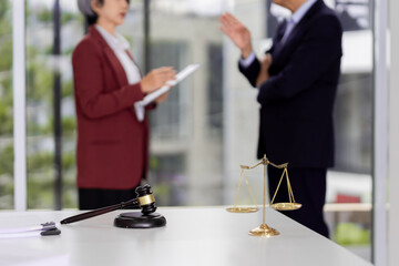 Legal professionals discuss important case issues modern office setting justice scales gavel...