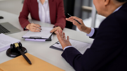 Asian legal professionals advise clients reviewing documents office business consultation expert...