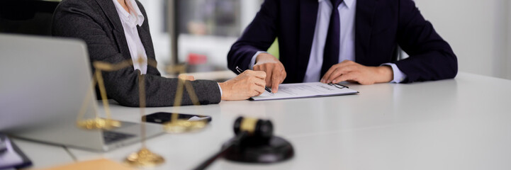 Professional lawyers clients review legal document signing contract agreement at modern law office...
