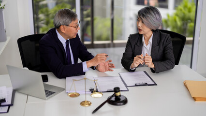 Asian adult legal professionals discuss important case details office consultation meeting client advice strategy