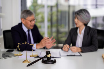 Asian legal professionals discuss important case details in office blurred faces focus on justice law legal consultation
