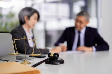 Legal professionals provide justice focused consultation in modern law office setting Asian adults...
