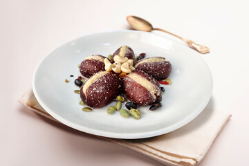 Elegant Stuffed Indian Sweets with Cashew and Nut Garnish on White Plate